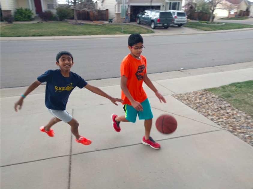 Aaron Vadakkan and brother play basketball
